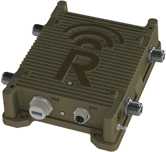 A rugged, rectangular electronic device with ribbed casing, labeled "R" on top. It has multiple connectors on the sides, and labeled USB and ETH ports on the front. The casing is olive green.