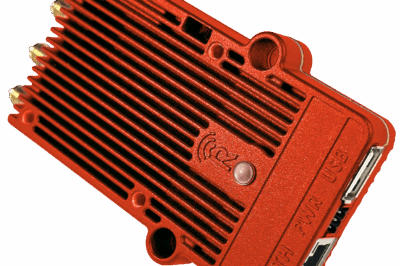 A red, rectangular electronic device with a ribbed texture, three antenna connectors, and ports labeled ETH, PWR, and USB on the side, resembling a network hardware component.