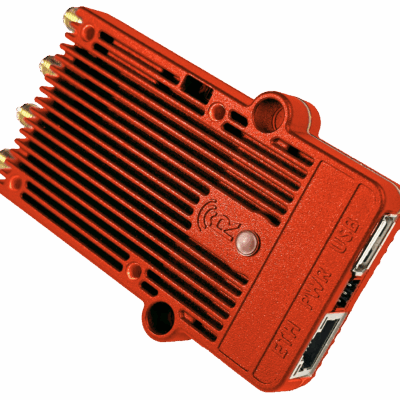A red, rectangular electronic device with a ribbed texture, three antenna connectors, and ports labeled ETH, PWR, and USB on the side, resembling a network hardware component.