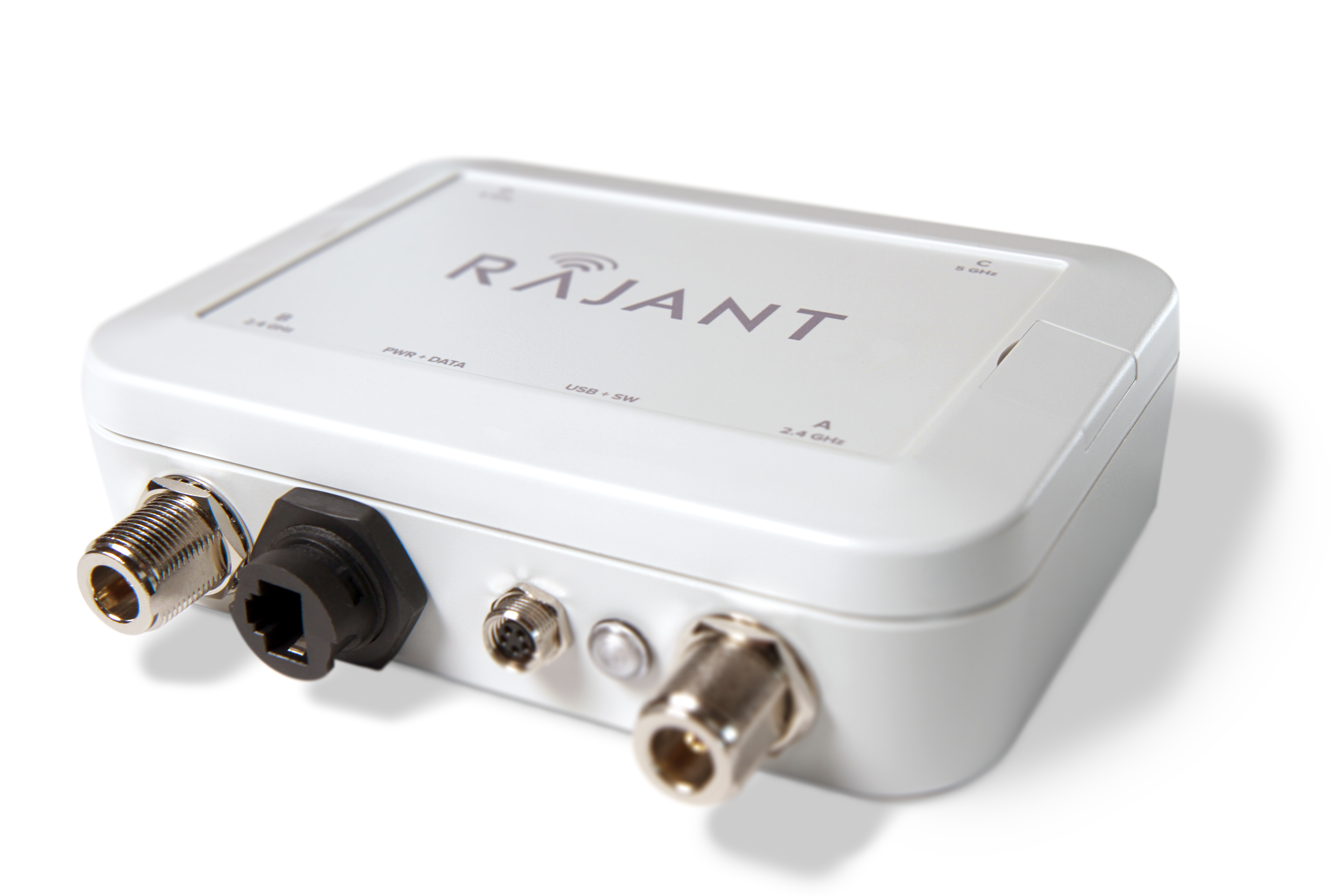 A white Rajant electronic device with multiple ports and connectors on one side, including Ethernet and coaxial ports, shown on a plain light background.