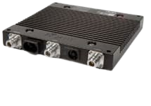 A black rectangular industrial electronic device with grooved top and four metallic connectors on the front side, isolated on a white background.