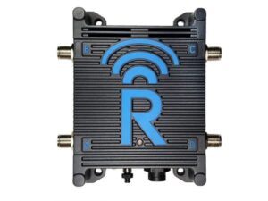 A black electronic device with four coaxial ports labeled A, B, C, and D at the corners, and a blue "R" with a wireless signal symbol on the top cover.
