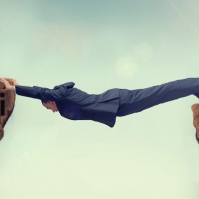 A man in a suit stretches across a gap between two cliffs labeled "Wi-Fi" and "LTE," symbolizing bridging the connection between wireless and cellular networks.