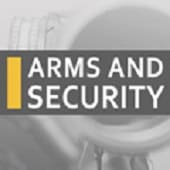 A gray banner with the words "Arms and Security" in bold white letters beside a vertical yellow bar, over a blurred background image of a gun barrel.