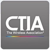 CTIA logo on a gray background with the words "The Wireless Association" below in white text and a thin rainbow-colored line underneath.