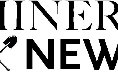 The image shows the words "MINERS NEWS" in bold, black text. Below "MINERS," there are crossed pickaxe and shovel icons, all set against a blue background.