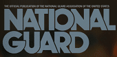 Large bold text reads "NATIONAL GUARD" with smaller text above stating "The official publication of the National Guard Association of the United States." The background is dark and blurred.