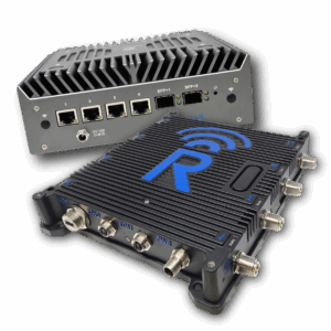 Two black, rectangular industrial network devices with multiple Ethernet ports, power connectors, and cooling vents. One device displays a large blue "R" logo with a wireless signal icon.