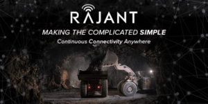 An underground mining loader dumps ore into a haul truck. The image is overlaid with the Rajant logo, the tagline "Making the Complicated Simple," and the phrase "Continuous Connectivity Anywhere." Network graphics are in the background.