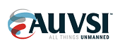 AUVSI logo with abstract red, blue, and gray shapes to the left and the text "AUVSI All Things Unmanned" in bold, dark letters on a white background.