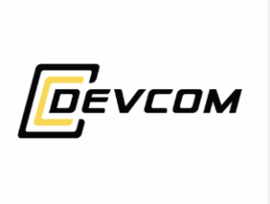 The image shows the DEVCOM logo. The word "DEVCOM" is written in bold, black letters, with the letter "D" highlighted in yellow and partially enclosed by two black, angular brackets. The background is white.