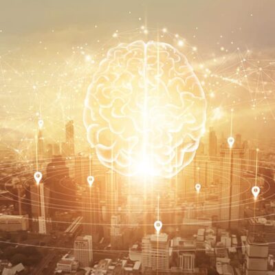 A glowing digital brain hovers above a cityscape, with network lines and location markers connecting across the image, symbolizing artificial intelligence and connectivity in urban technology.