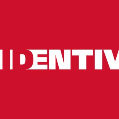 White word "IDENTIV" on a red background. The first letter "I" is formed by a white vertical rectangle and a smaller square, followed by the rest of the word in bold, modern font.
