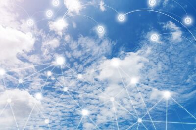 A blue sky with white clouds is overlaid with a network of glowing, interconnected nodes and lines, symbolizing digital connectivity and cloud computing.
