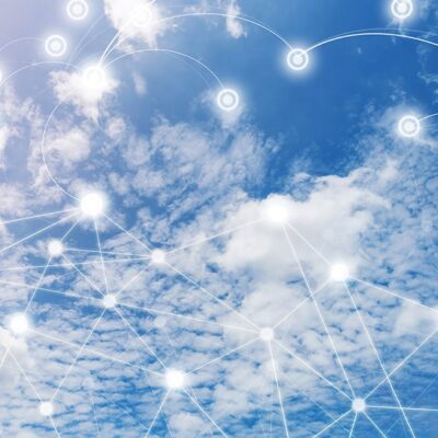 A blue sky with white clouds is overlaid with a network of glowing, interconnected nodes and lines, symbolizing digital connectivity and cloud computing.