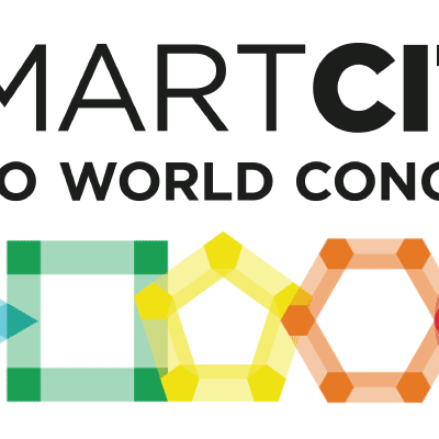 Logo for Smart City Expo World Congress, featuring bold black text and colorful geometric shapes—a triangle, square, pentagon, and hexagon—arranged in a row below the text on a white background.