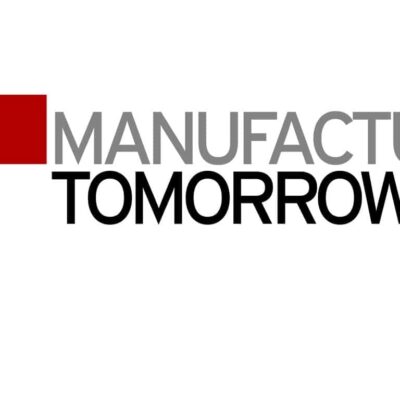 Logo with a red geometric shape on the left and the words "MANUFACTURING TOMORROW" in gray and black text on the right.