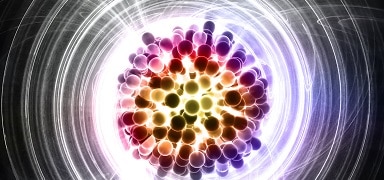 A colorful digital illustration of an atom's nucleus, with clustered particles in shades of red, purple, yellow, and white, surrounded by swirling, glowing energy lines on a dark background.