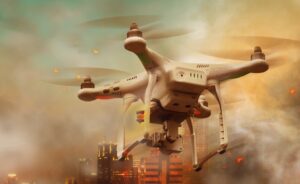 A white quadcopter drone flies in smoky, orange-tinted air above a cityscape with tall buildings, some lights illuminated, and debris or embers floating in the sky.