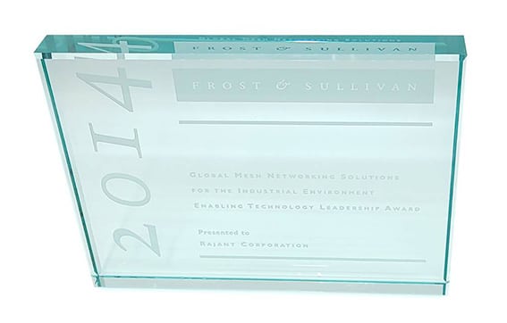 A glass award plaque with "2014" etched vertically on the left and "Frost & Sullivan" at the top. It recognizes Rajant Corporation for Global Mesh Networking Solutions in the industrial environment.