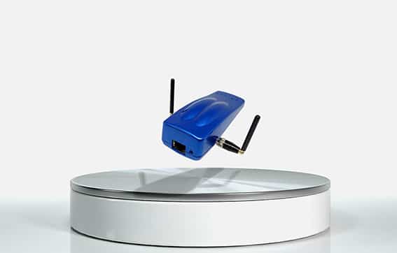 A small blue wireless router with two antennas appears to be floating above a round, white platform against a plain white background.